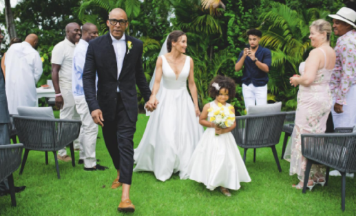 The wedding guests stand to honour the newlyweds